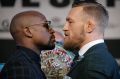 Floyd Mayweather jnr, left, and Conor McGregor during a news conference on Wednesday in Las Vegas.