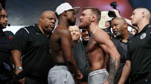 Ready to go: Floyd Mayweather and Conor McGregor stare each other down during weigh-ins.