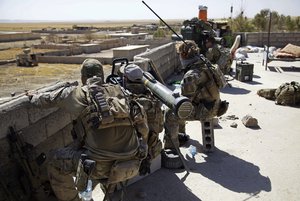 Belgian and U.S. troops take up positions on a rooftop with a guided-missile launcher, a few miles from the frontline, in the village of Abu Ghaddur, east of Tal Afar, Iraq, Sunday, Aug. 20, 2017. Iraqi forces have launched a multi-pronged assault to retake the town of Tal Afar, west of Mosul, marking the next phase in the country's war on the Islamic State group. Tal Afar and the surrounding area is one of the last pockets of IS-held territory in Iraq after victory was declared in July in Mosul, the country's second-largest city.