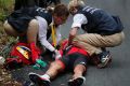 Australia's Richie Porte gets medical assistance after crashing in the descent of the Mont du Chat pass during the ninth ...