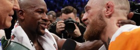 Floyd Mayweather Jr, left, speaks with Conor McGregor after winning the super welterweight boxing match 
 on Saturday.