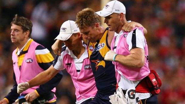 Sam Mitchell leaves the field after hurting his ankle against Sydney.