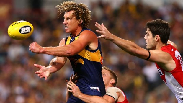 West Coast's Matt Priddis fires off a handball just in time.