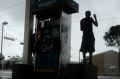 A man watches heavy rain from the relative safety of a flooded petrol station caused by Tropical Storm Harvey in Houston ...