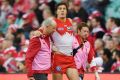 Scare: Kurt Tippett is helped off the pitch after re-injuring his ankle against Carlton at the SCG.