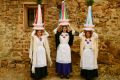 Three woman called ''Las Mondidas'' pose in front of an old house before taking part in the religious pilgrimage in ...