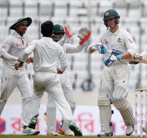 Bangladesh's Taijul Islam, second from right, celebrates with his teammates after the dismissal of Australia's Peter ...