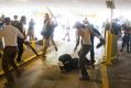 DeAndre Harris, bottom is assaulted in a parking garage beside the Charlottesville police station after a white ...