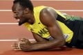Jamaica's Usain Bolt lies on the track after injuring himself during the men's 4x100m final at the World Athletics ...