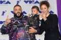 DJ Khaled, left, Nicole Tuck, right, and their son Asahd arrive at the MTV Video Music Awards.
