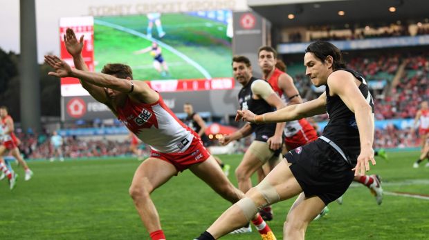 Frantic: Jake Lloyd attempts to smother a kick by Zac Fisher.