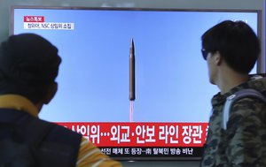 People watch a TV screen showing a file footage of North Korea's missile launch, at the Seoul Railway Station in Seoul, South Korea, Tuesday, Aug. 29, 2017.