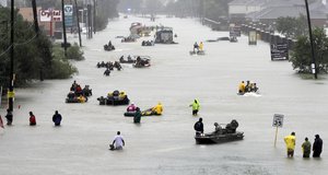 Rescue boats fill a flooded street at flood victims are evacuated as floodwaters from Tropical Storm Harvey rise Monday, Aug. 28, 2017, in Houston. (AP Photo/David J. Phillip)