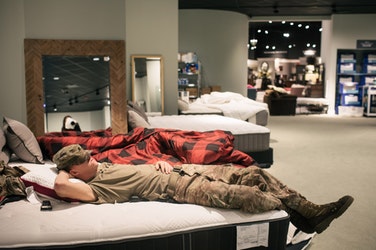 Spc. Robert Herden, a member of the National Guard who spent the night rescuing the crew and residents of a nursing home, sleeps at a Gallery Furniture store in Richmond, Texas, Aug. 29, 2017.