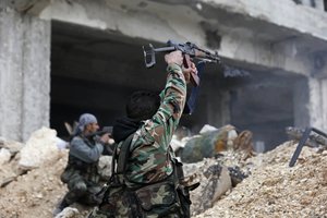 Syrian army soldiers fire their weapons during a battle with rebel fighters at the Ramouseh front line, east of Aleppo, Syria, Monday, Dec. 5, 2016.