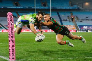 Where have the crowds gone? Canberra winger Michael Oldfield evades a tackle from Tyrell Fumaono to score. The round 21 ...