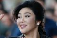 Former Thai prime minister Yingluck Shinawatra waves to supporters as she arrives at the Supreme Court for her final ...