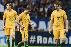 Heartbreak: Australia look dejected after conceding a goal to Japan.