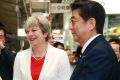 British Prime Minister Theresa May and Japanese Prime Minister Shinzo Abe, right, wait for their bullet train bound for ...