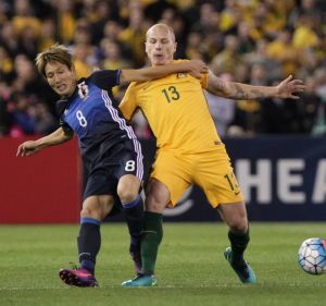 Rematch: Aaron Mooy and Japan's Genki Haraguchi battle hard for the ball during last year's World Cup qualifier in Melbourne.