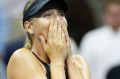 Maria Sharapova reacts after defeating Simona Halep 6-4, 4-6, 6-3 in their opening round match in the U.S. Open tennis ...