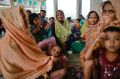 Members of Myanmar's Muslim Rohingya minority  sit at a temporary shelter at Shah Porir Deep.