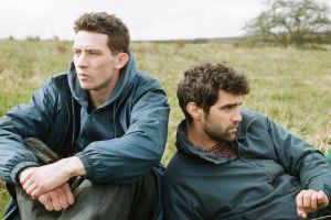 Josh O'Connor and Alec Secareanu star in the rural love story God's Own Country.