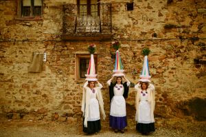 Three woman called ''Las Mondidas'' pose in front of an old house before taking part in the religious pilgrimage in ...