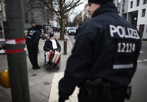 Police officers help people during the evacuation of apartment blocks after a bomb of World War II has been found in the area of Berlin's main train station in Berlin on Wednesday, April 3, 2013.