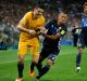 Australia's Tom Rogic, left, and Japan's Yosuke Ideguchi contest for the ball during their World Cup Group B qualifying ...