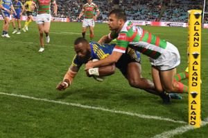 Hat-trick hero: Semi Radradra scores despite the efforts of Luke Kelly.