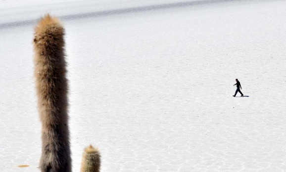 A tourist is seen walking along the salt flats at the Uyuni salt flats, Bolivia.