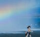 A walker passes a rainbow in the Captain Cook Jet on Thursday afternoon.