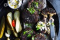 Pumpernickel pork patties with gherkin mayo and pickles.