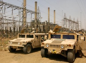 Soldiers prepare to begin a convoy near one of Baghdad's main power plants, which Coalition forces are helping to keep secure in order to provide the best possible quality of life for Iraqi people. The Soldiers are assigned to the 1st Cavalry Division, de