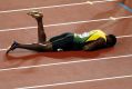 Dramatic finale: Usain Bolt lies on the track after pulling up injured in the final leg of the 4x100m relay at the World ...