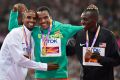 Ethiopia's Muktar Edris (centre) celebrates 5000-metre gold with silver medalist Mo Farah, left, and bronze medalist ...
