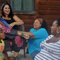 Rachel Zaslow, left, started Sisters Keeper Collective two years ago, after seeing a need for doulas of color to help Latina and African-American women. Crystal Johnson, right, serves as the doula coordinator for the group, and Doreen Bonnet, middle, is a doula-in-training. Photo by Natalie Jacobsen.