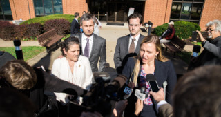 Nicole Eramo, left, leaves the courthouse after a jury found in her favor, with her attorneys Tom Clare, Andy Phillips and LIbby Locke. Photo Eze Amos