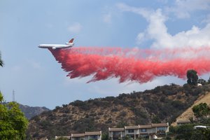 A DC-10 Tanker Air Carrier drops Phos-Chek retardant across a ridge while fighting the "LaTuna Fire" on the hillside in Burbank, Calif., Saturday, Sept. 2, 2017. The DC-10 delivers some 11,600 gallons of retardant per load. Several hundred firefighters worked to contain a blaze that chewed through brush-covered mountains, prompting evacuation orders for homes in Los Angeles, Burbank and Glendale.