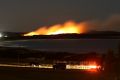 A bushfire burns near the Kurnell oil refinery overnight.