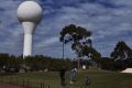 Teeing off: golfers next to the bureau's Doppler Radar site at Terrey Hills.