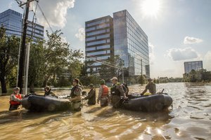 Marines Corps reservists work with members of the Texas State Guard and Texas Highway Patrol to pull Marine Corps combat rubber raiding craft through a flooded street in Houston, Aug. 31, 2017, while supporting Harvey relief efforts.