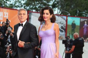 Director George Clooney and his wife Amal Clooney pose for photographers upon arrival at the premiere of the film ...