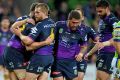 Storm players celebrate a try against the Raiders.