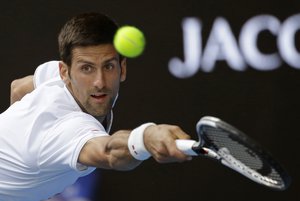 Serbia's Novak Djokovic reaches for a return to Uzbekistan's Denis Istomin during their second round match at the Australian Open tennis championships in Melbourne, Australia, Thursday, Jan. 19, 2017.