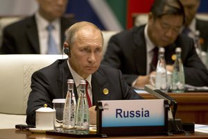 Russian President Vladimir Putin listens to a speech during the Dialogue of Emerging Market and Developing Countries in Xiamen in southeastern China’s Fujian Province, Tuesday, Sept. 5, 2017.