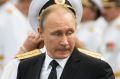 Russian sailors stand in attention as Russian President Vladimir Putin leaves after attending the military parade during ...