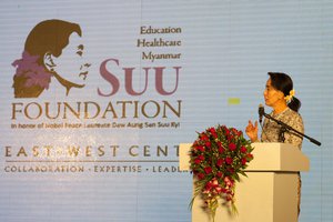 File - Nobel Peace Prize laureate Daw Aung San Suu Kyi addresses the participants of the East-West Center International Media Conference at a special pre-conference luncheon and announced the launch of the Suu Foundation, Myanmar, 9 March 2014.