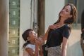Angelina Jolie (right) with Sareum Srey Moch as a young Loung Ung during the film shoot. Jolie says going to Cambodia ...